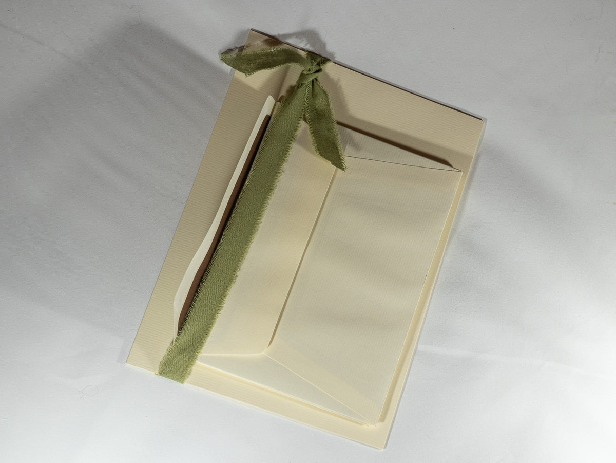 Luxury cream stationery and envelopes tied with soft sage ribbon, part of The Irish Daisy curated gift collection