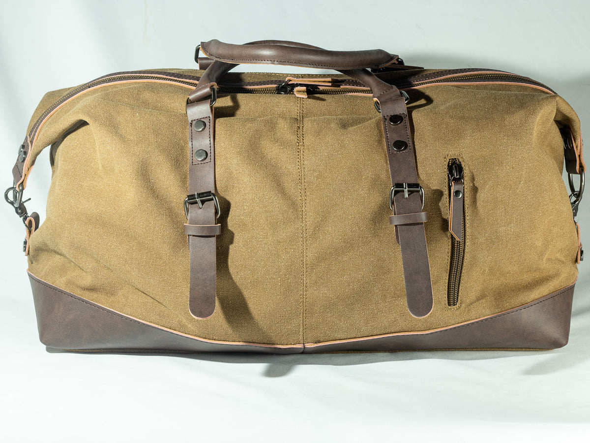 Khaki canvas weekender bag with brown leather straps and trim