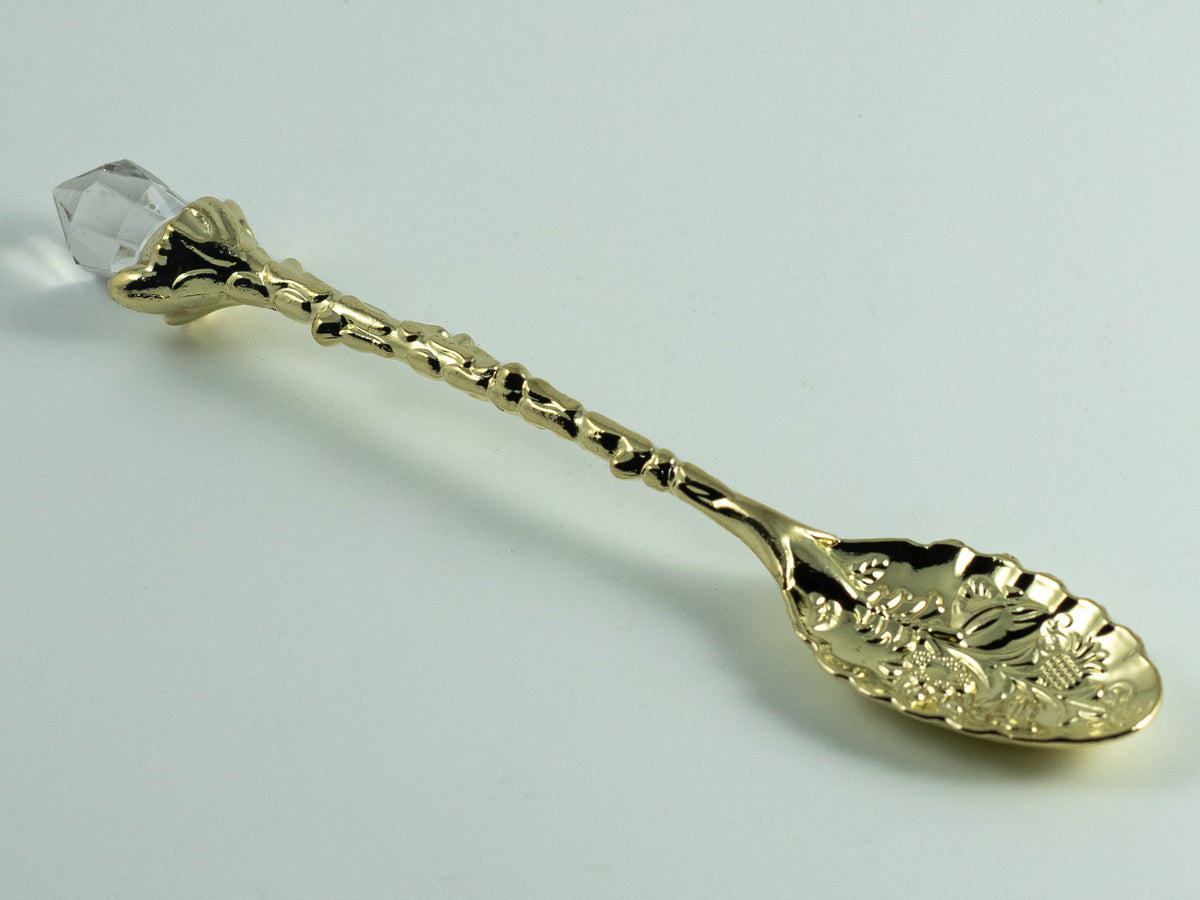 Ornate gold demitasse spoon with clear crystal handle topper