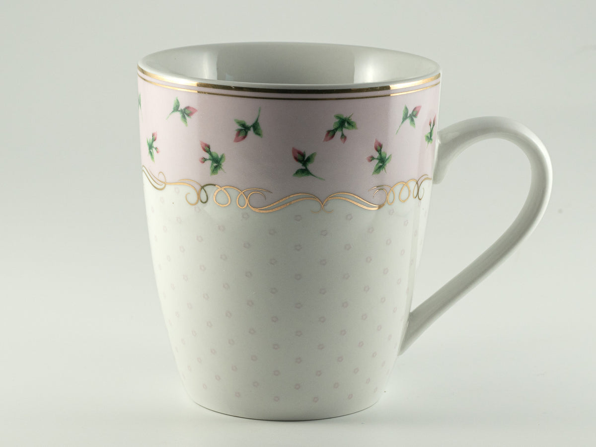 Blush and ivory floral tea mug with delicate gold trim on a soft white background.

