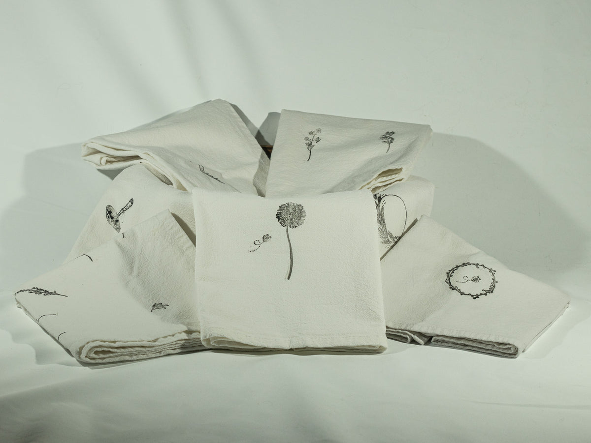 Collection of hand stamped cotton kitchen towels.
