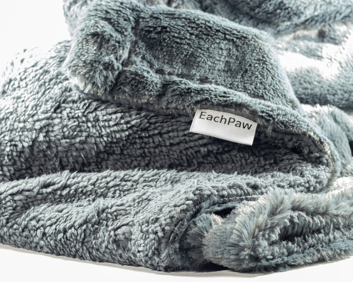 A plush fleece blanket in a charcoal gray color for your favorite dog.