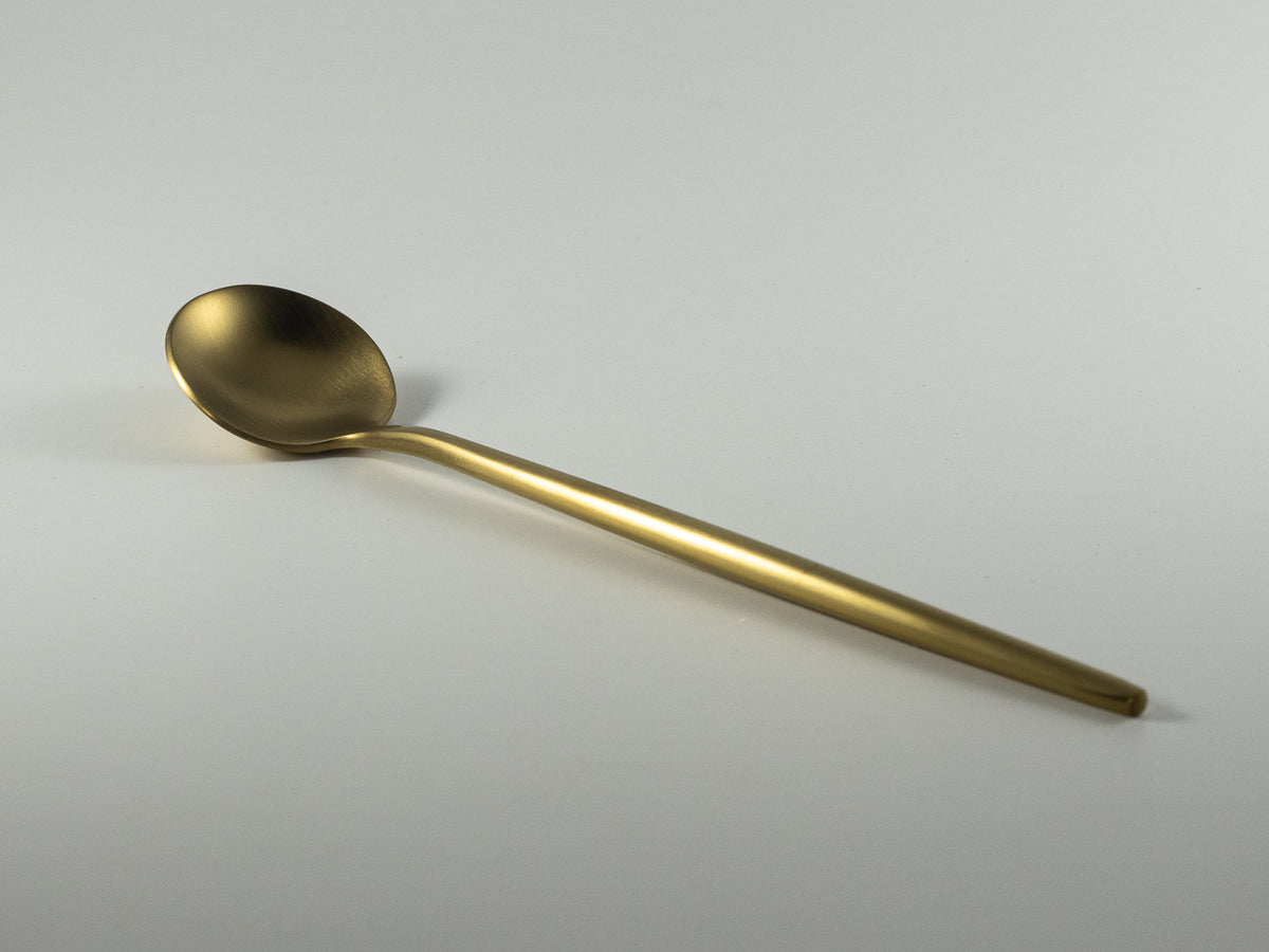 Slim gold-tone stirring spoon for coffee and tea in The Irish Daisy gift collection.