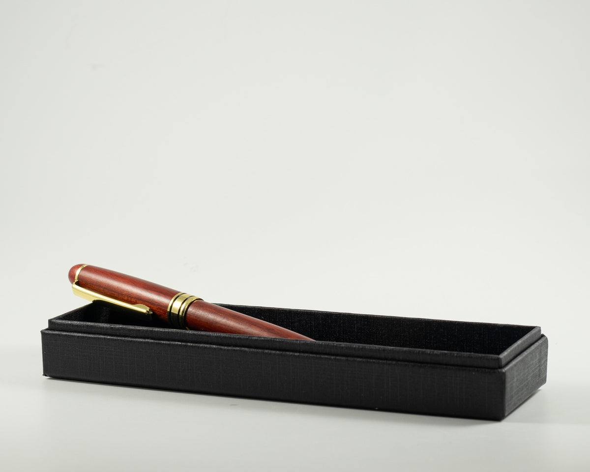 Elegant rosewood pen with gold accents for gifting and part of Letters & Legacy basket.