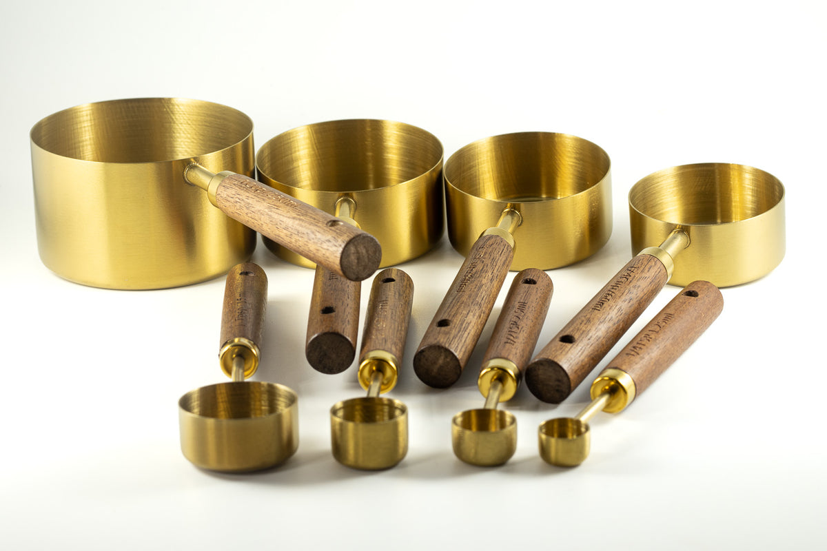 Gold measuring cups and spoons with wood handles for The Irish Daisy Warm Oven gift.