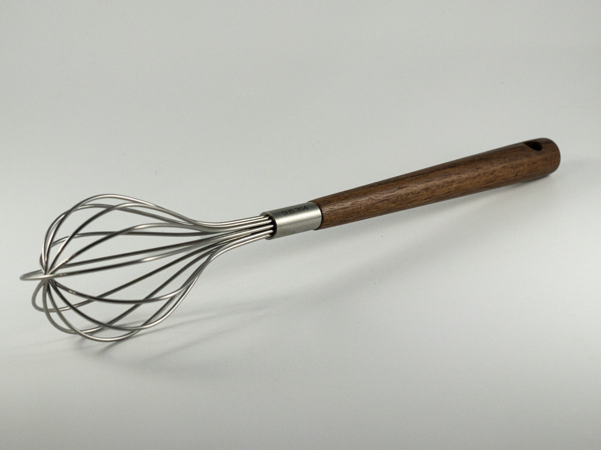 Small stainless steel whisk with walnut wood handle for The Irish Daisy Warm Oven gift.