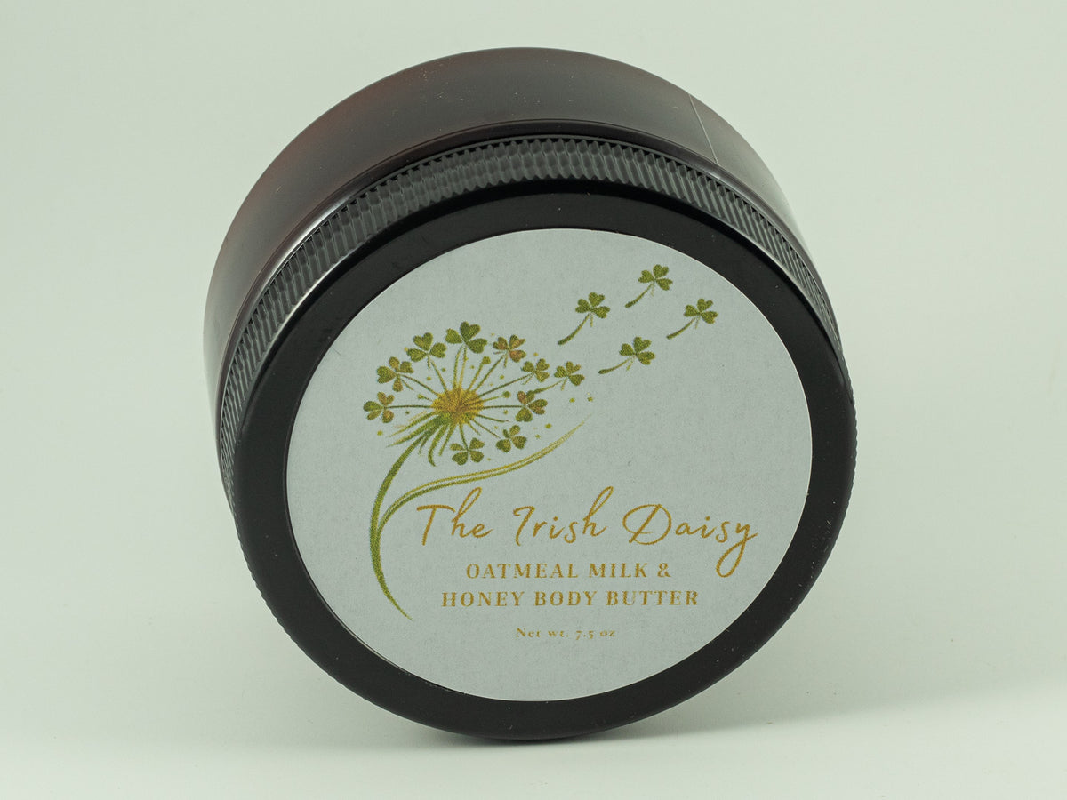 Jar of luxe Oatmeal Milk & Honey body butter with a white Irish Daisy label featuring a delicate botanical design.
