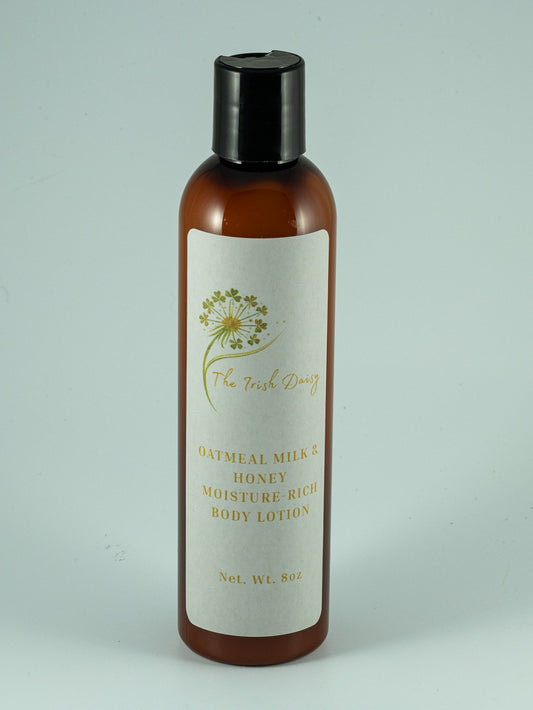 Amber bottle of Oatmeal Milk & Honey moisture-rich body lotion with a white Irish Daisy botanical label.
