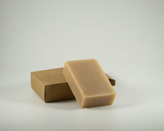 Handcrafted oatmeal, milk, and honey soap bar with a creamy natural finish, displayed with a kraft gift box for a soothing, luxurious bathing experience.