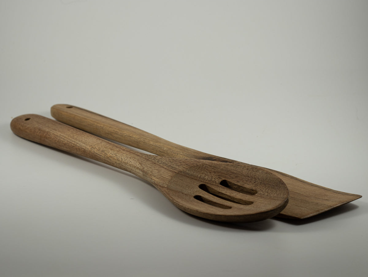 Set of two natural wooden serving utensils, including a slotted spoon and flat serving spoon.