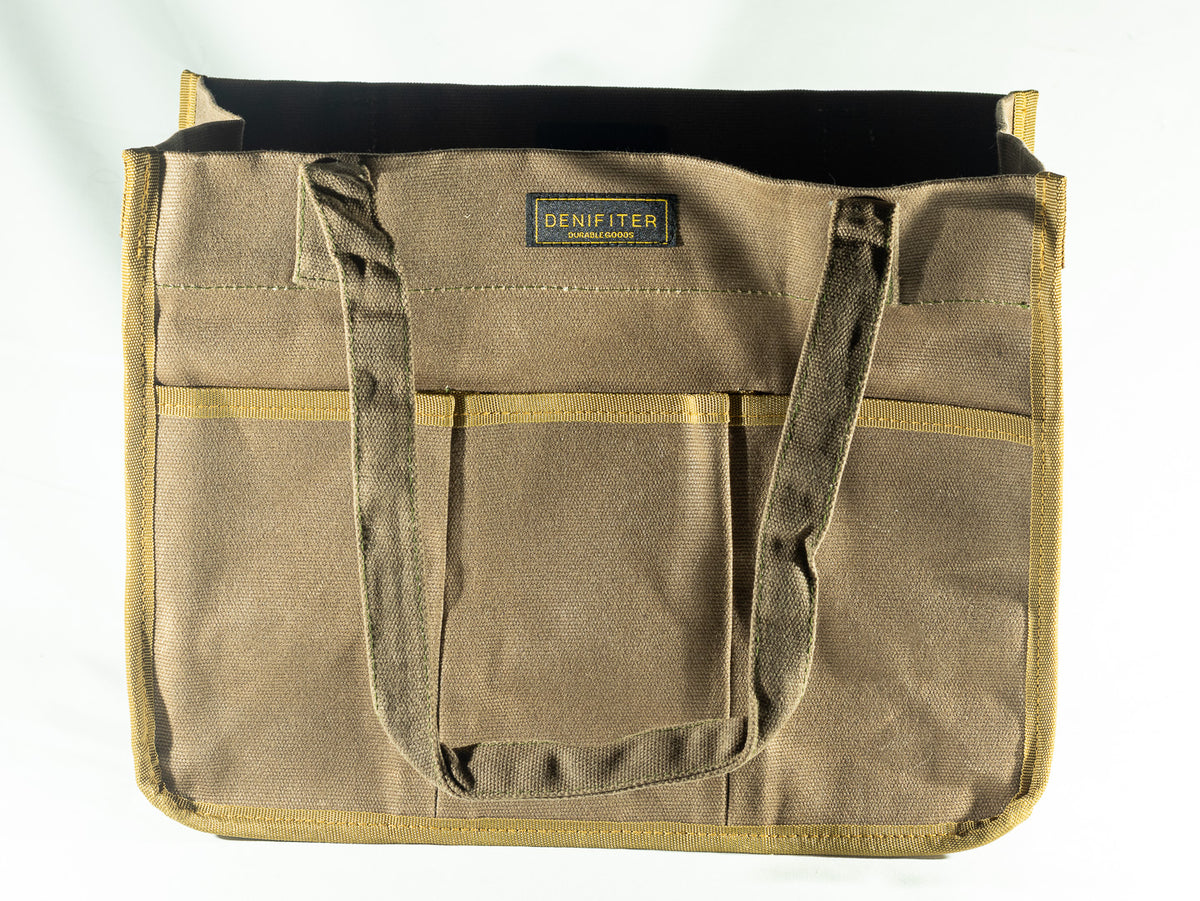 Brown structured canvas tote with exterior pockets and warm contrasting trim, used as the vessel for The Irish Daisy Heritage Outdoorsman gifts.
