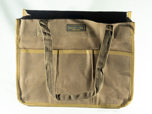 Brown structured canvas tote with exterior pockets and warm contrasting trim, used as the vessel for The Irish Daisy Heritage Outdoorsman gifts.