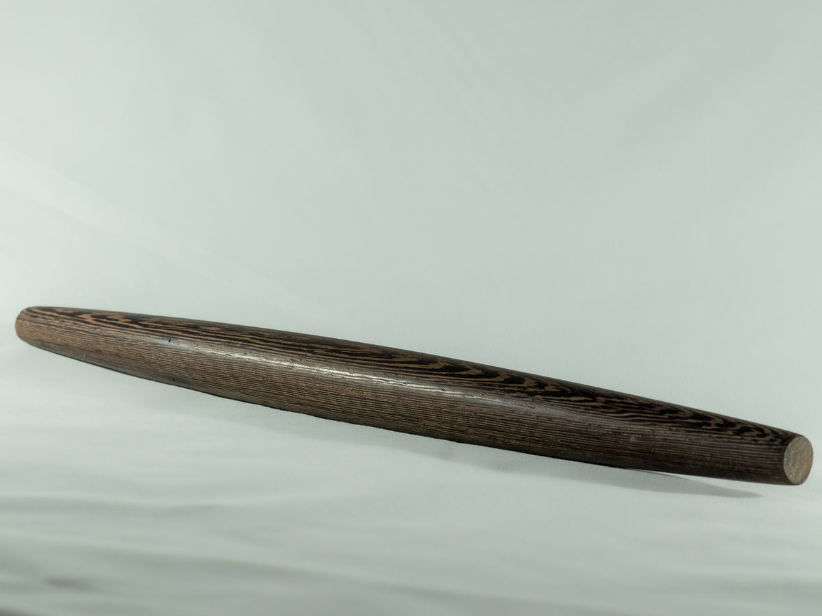 Dark wood French rolling pin with a tapered shape and visible natural wood grain.