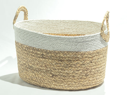 A woven storage basket with a natural seagrass body, a white rope trim, and two rope handles.